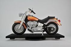 a toy motorcycle sitting on top of a black stand