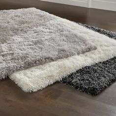 an area rug is shown on the floor in front of a window with white trim