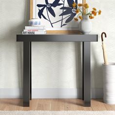 a vase with flowers and an umbrella on a table in front of a wallpapered background