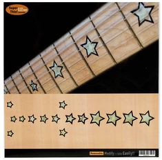 an image of a guitar string with stars on the fret and inlays