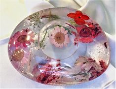 a glass plate with flowers painted on it