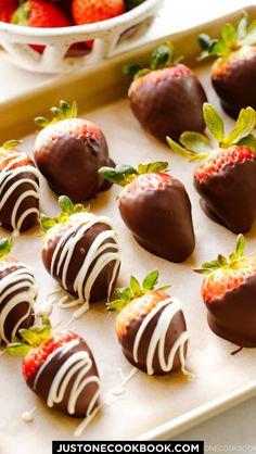 chocolate covered strawberries are arranged on a baking sheet