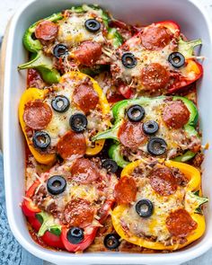 a casserole dish filled with pepperoni, peppers and cheese topped with olives