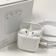 an open box with two airpods in it