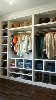 an organized closet with clothes and shoes on the shelves in front of it is shown