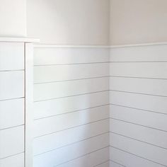 the corner of a room with white painted walls