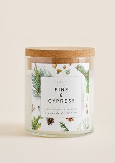 a candle with pine and cypress on it