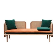 two couches with green pillows on each one and brown cushions on the other side