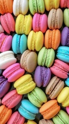 many different colored macaroons are arranged together