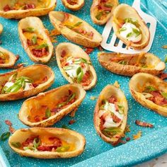 small appetizers are arranged on a blue tray