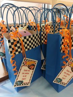 blue bags with orange ribbons and tags on them