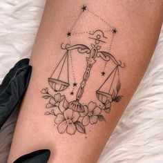 a lady justice symbol tattoo on the leg