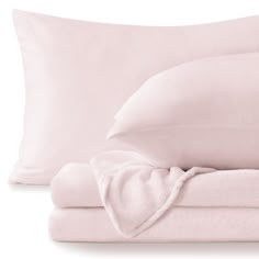 a bed with pink sheets and pillows next to each other on a white background,