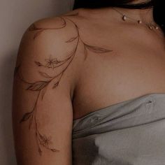 a woman with a tattoo on her shoulder