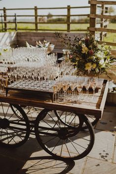 a wooden cart filled with lots of wine glasses