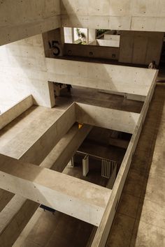 an aerial view of a building with concrete walls and flooring, looking down at the ground