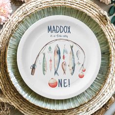 there is a plate with fish on it and the words maddox are painted on it