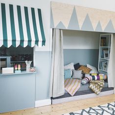 a child's bedroom with a tent bed and bookshelf