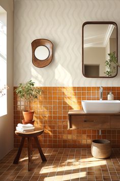 a bathroom with a sink, mirror and potted plant