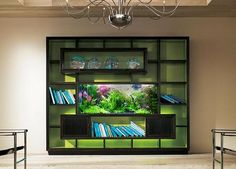 a living room filled with lots of furniture and a fish tank on top of a shelf