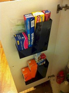 a bathroom with toilet paper and toothbrushes hanging on the wall next to it