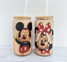 two jars with mickey and minnie mouse designs on them