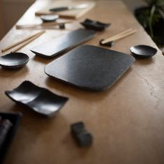 spoons and spatulas are laid out on a table