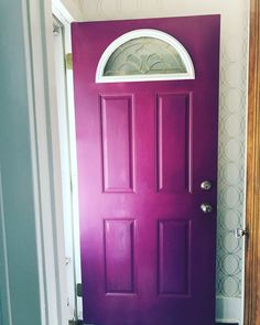 a purple door in a white room