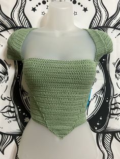 a crocheted crop top on a mannequin