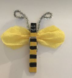 a yellow and black tie with some silver beads on it's ends is attached to a key chain