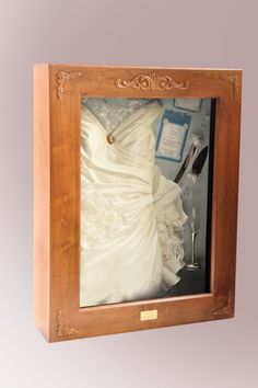 a wedding dress in a wooden frame