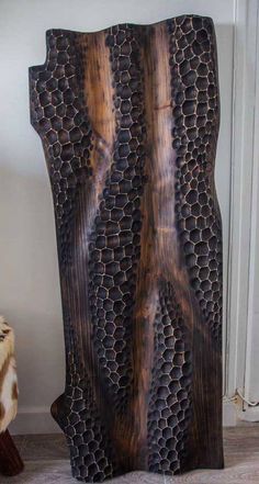 a piece of wood that has been carved to look like honeycombs