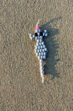 an odd looking object on the sand in the middle of the beach, made out of plastic bottles