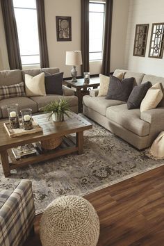 a living room filled with furniture and windows