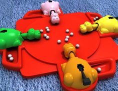 a red tray with several different colored toys on top of blue carpeted flooring