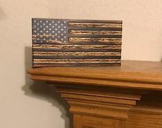 an american flag is sitting on top of a mantle