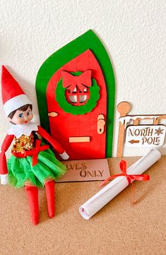 an elf is sitting in front of a red door