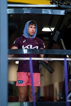 a rugby player is standing in the gym