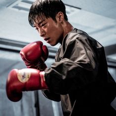 a young man is practicing his boxing skills