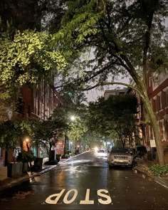 an empty street at night with the word dols painted on the road in white