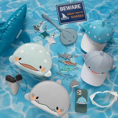 various items that include hats, keys and other things in the shape of animals are on a blue surface