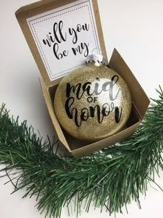 a christmas ornament in a box with the words, will you be my maid?