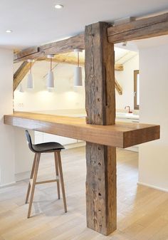 an empty room with a bar and stools