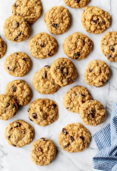 chocolate chip oatmeal cookies laid out on top of a white marble counter