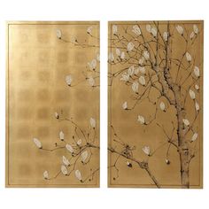 two gold paintings with white flowers and leaves on the same wall, one has a tree in front of it