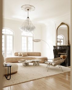 a living room filled with furniture and a fire place next to a mirror on the wall