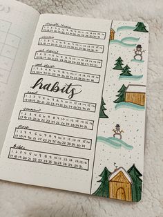 an open notebook with the words habit written on it and snowing in the background