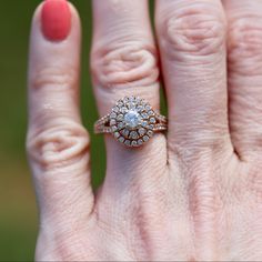 a close up of a person's hand with a diamond ring on top of it