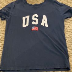 Blue Never Worn Usa T-Shirt Vintage Brandy Melville, Bur Basket, Brandy Clothes, Tsitp Dr, Cricket Shirts, Brandy Melville Shirts, Pinterest Wardrobe, Brandy Melville Outfits, Preppy Things