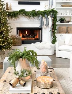 a living room filled with furniture and a christmas tree in front of a fire place